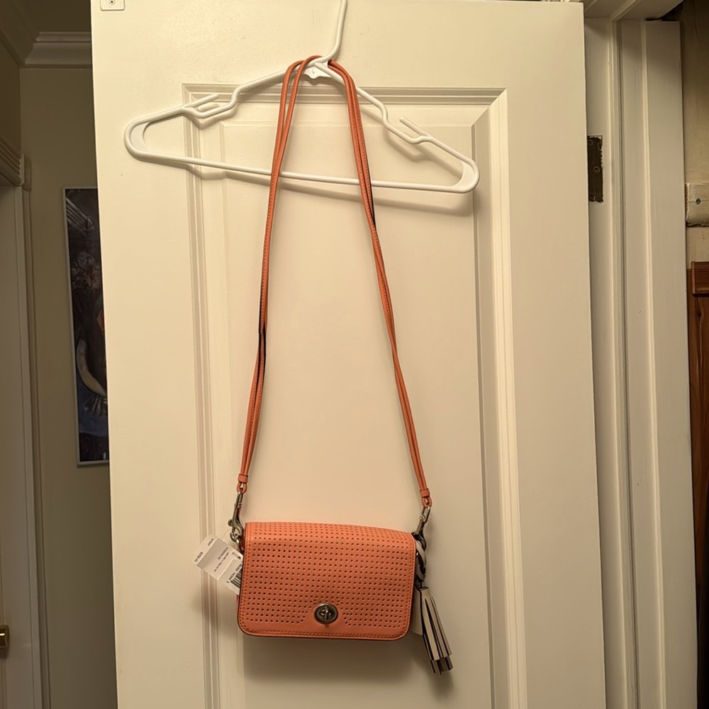Coach leather crossbody bag; coral color; light sand tassels; new with tags